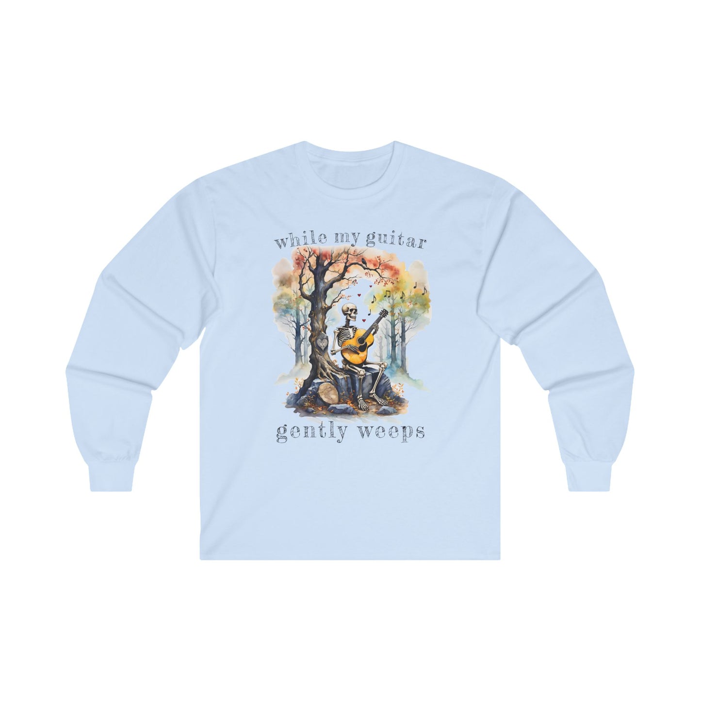 This gothic skeleton long sleeve t-shirt featuring a grisly guitarist jamming on an acoustic guitar in a haunting watercolor forest is a stunning tongue-in-cheek homage to the Beatles music. This haunting design looks great on this light blue Gildan unisex heavy cotton long sleeve t-shirt.