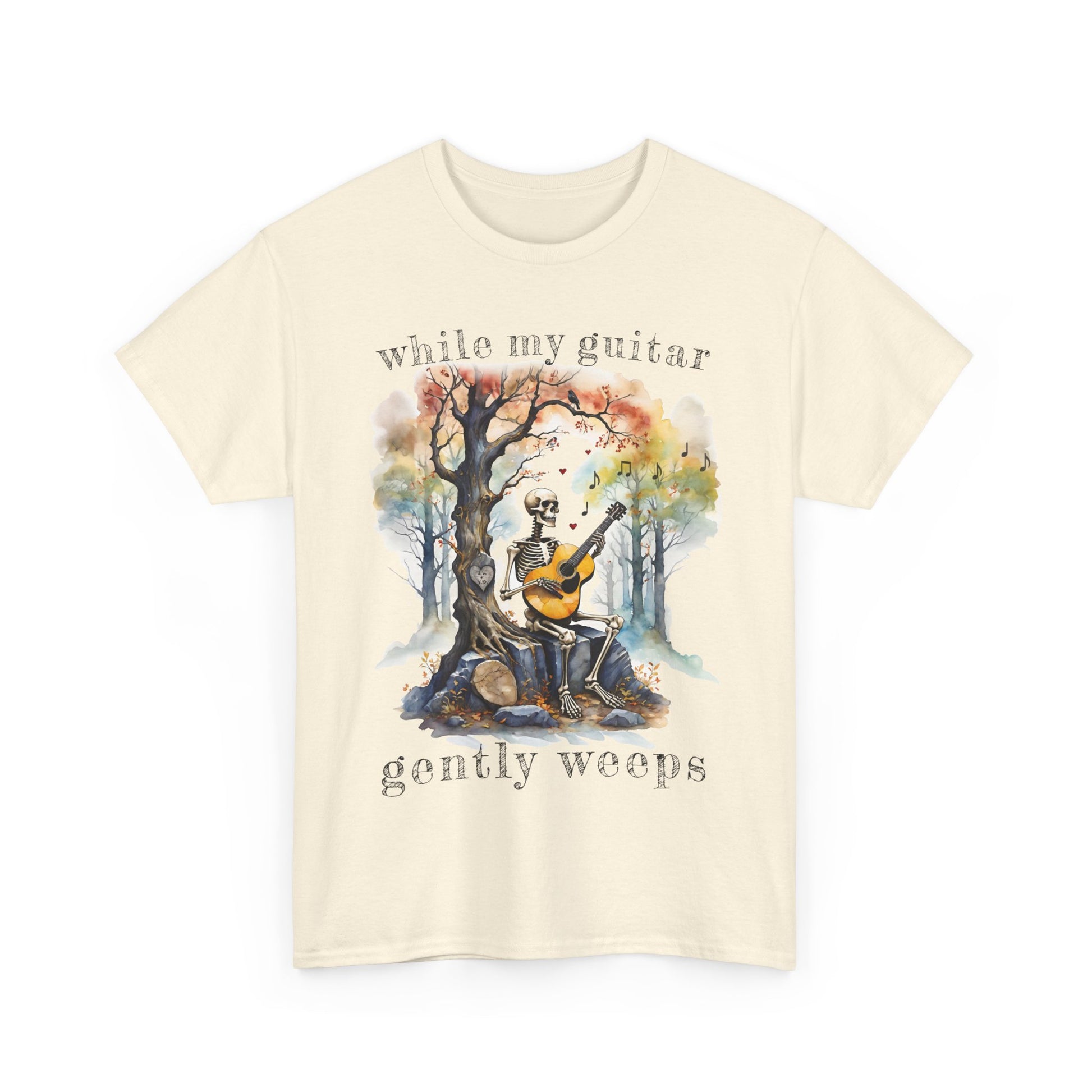 This gothic skeleton T-shirt featuring a grisly guitarist jamming on an acoustic guitar in a haunting watercolor forest is a stunning tongue-in-cheek homage to the Beatles music. This stunning design looks great on this  natural colored Gildan unisex heavy cotton t-shirt.