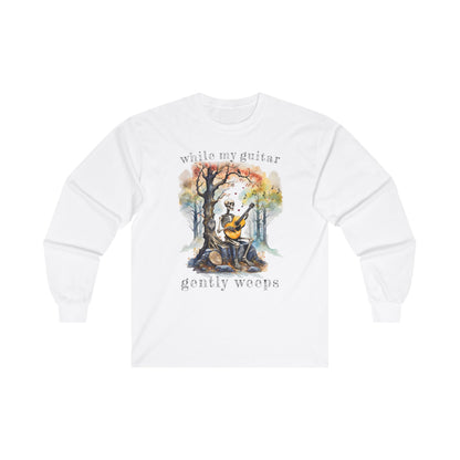 This gothic skeleton long sleeve t-shirt featuring a grisly guitarist jamming on an acoustic guitar in a haunting watercolor forest is a stunning tongue-in-cheek homage to the Beatles music. This haunting design looks great on this white Gildan unisex heavy cotton long sleeve t-shirt.