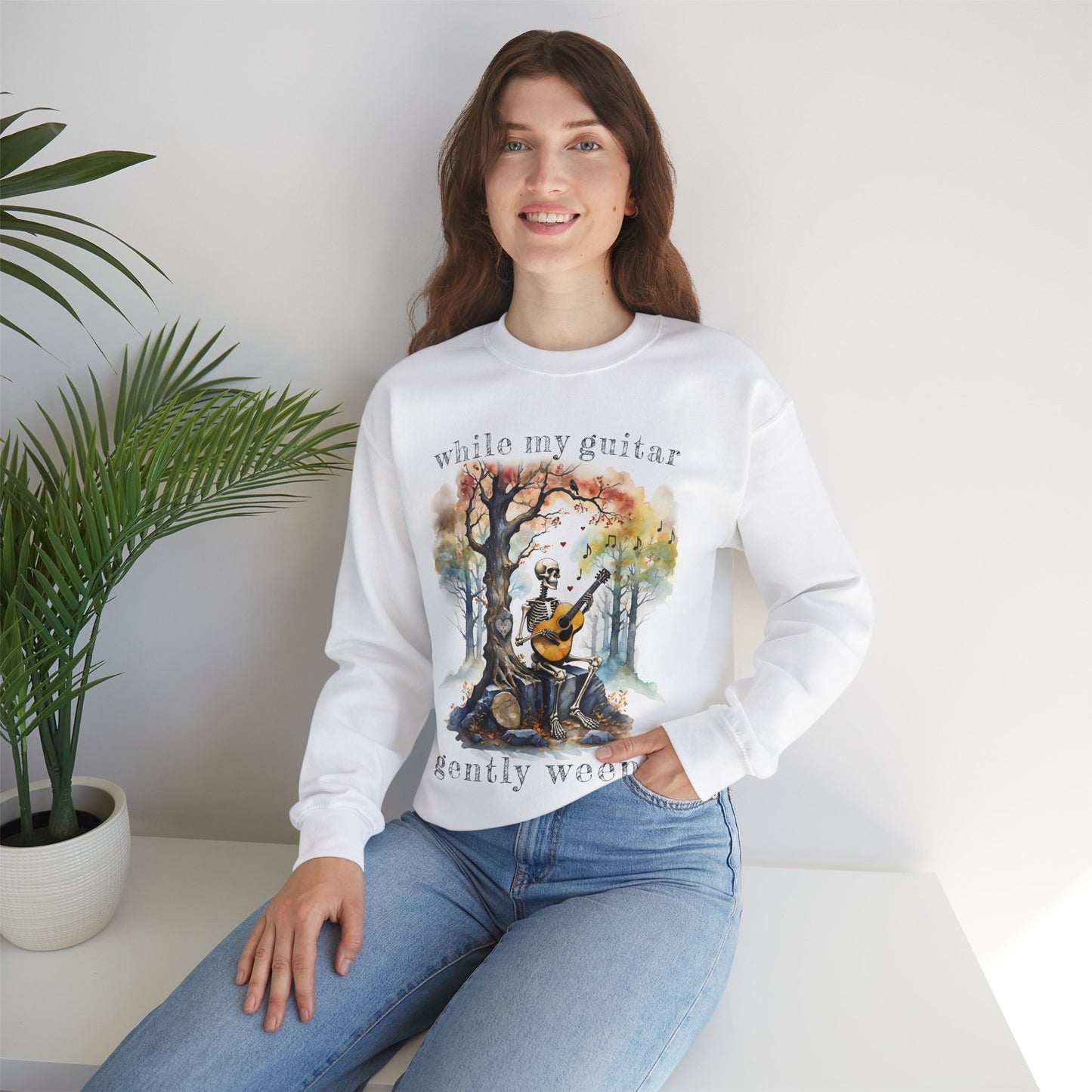 This gothic skeleton sweatshirt featuring a grisly guitarist jamming on an acoustic guitar in a haunting watercolor forest is a stunning tongue-in-cheek homage to the Beatles music. This stylish lady looks great in this Gildan unisex heavy cotton sweatshirt.