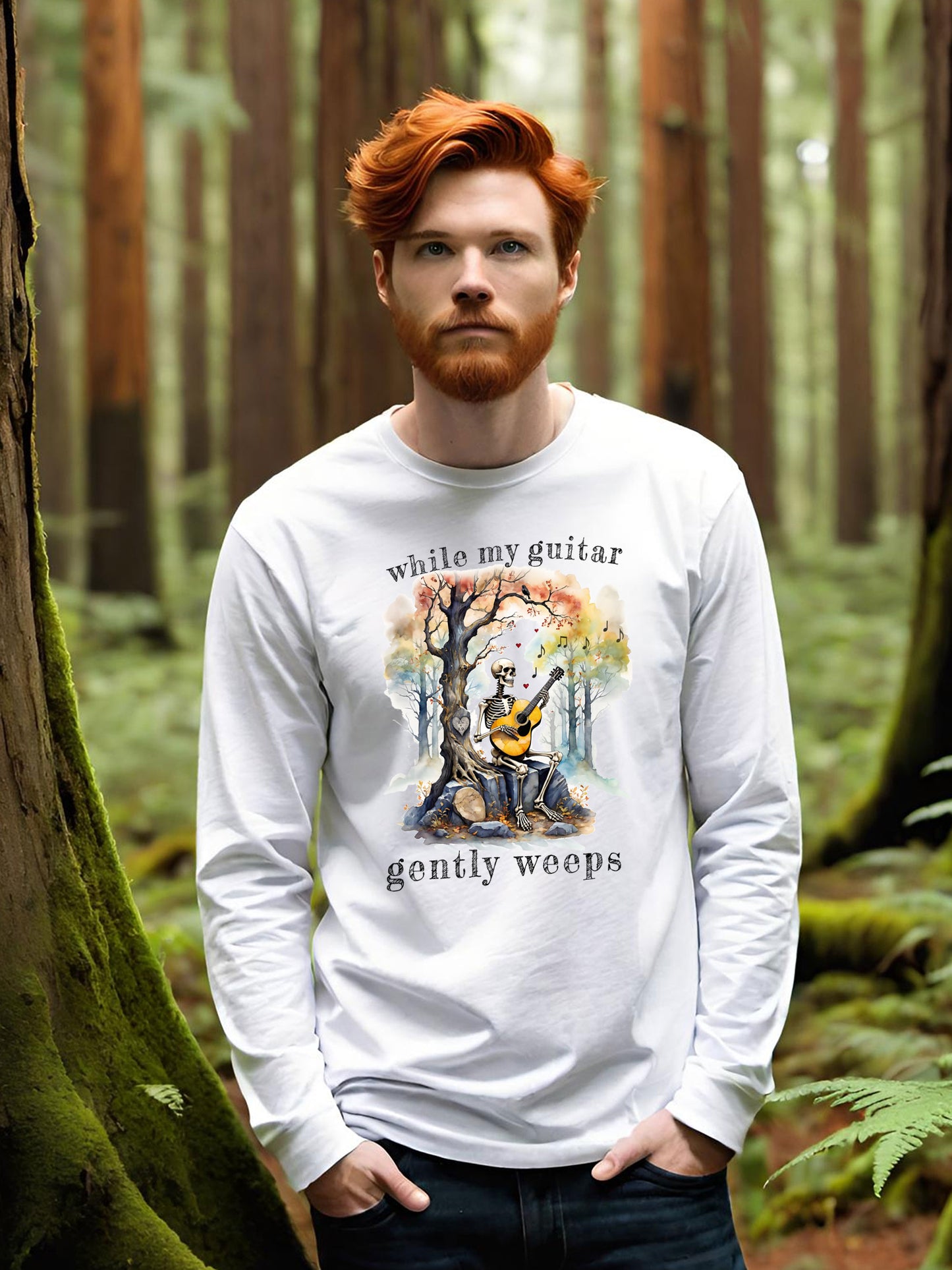 This gothic skeleton long sleeve t-shirt featuring a grisly guitarist jamming on an acoustic guitar in a haunting watercolor forest is a stunning tongue-in-cheek homage to the Beatles music. This cool-dude looks great in this Gildan unisex heavy cotton long sleeve t-shirt.