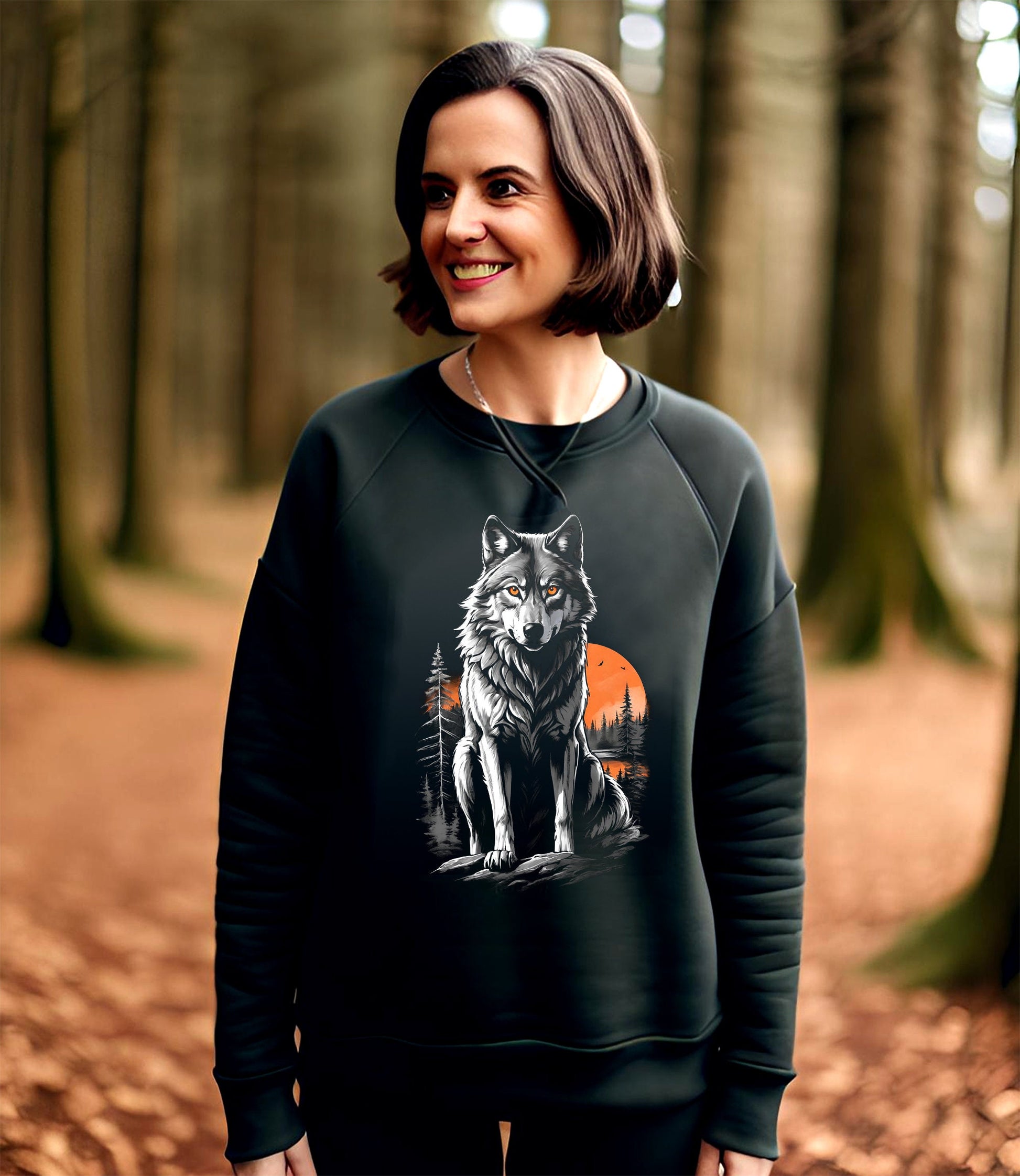 This Wolf Hoodie is a haunting depiction of the North American Grey Wolf. This beautiful animal is on the endangered species list. This image features a stunning grey wolf with a beautiful orange sunset with a forest of muted grey pine trees.