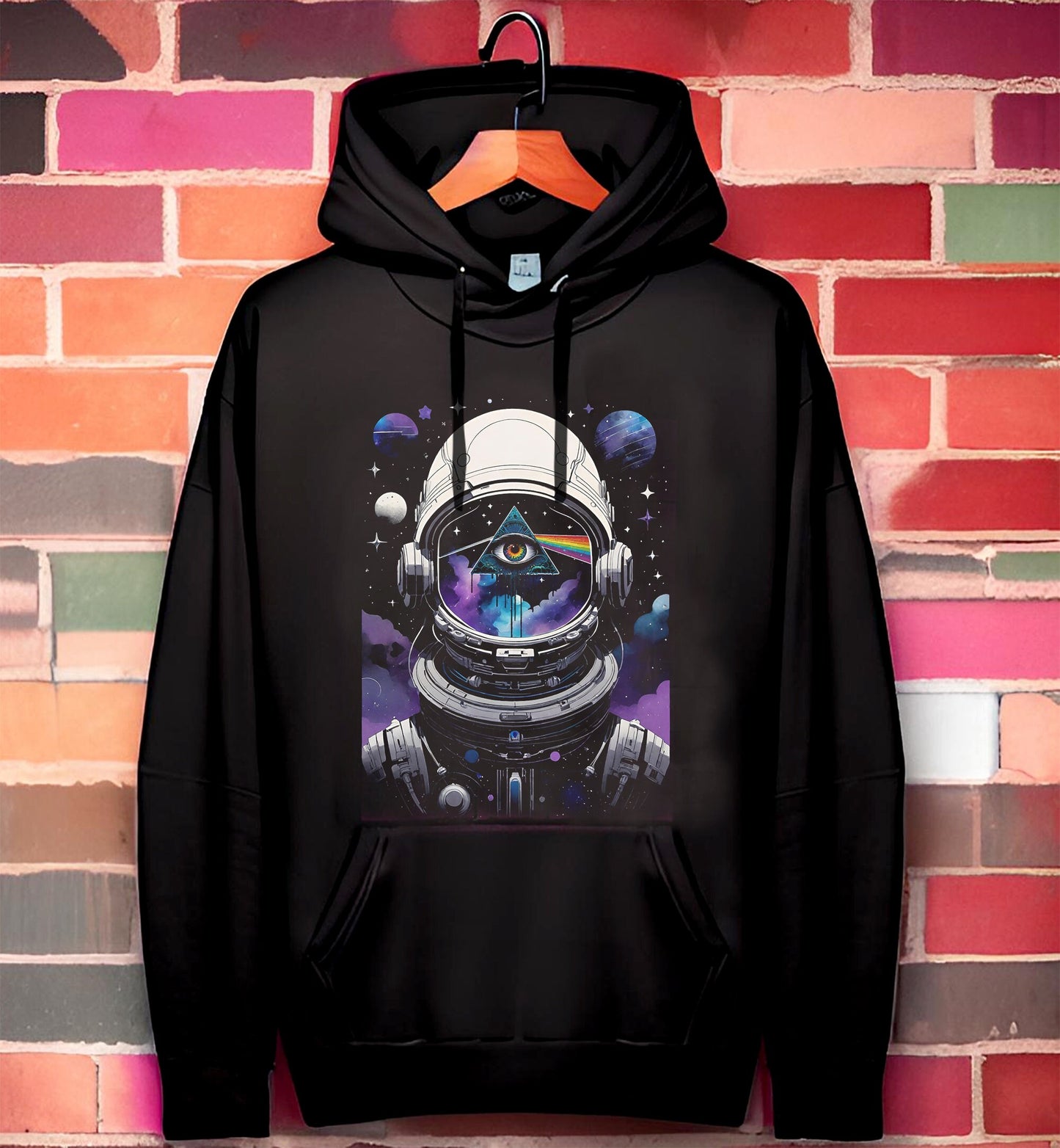 If you are a fan of Pink Floyd the way I am, you are going to love this truly cosmic take on the Dark side of the moon. This stunning Pink Floyd Hoodie featuring a spaceman in a purple, black, blue and white motif.