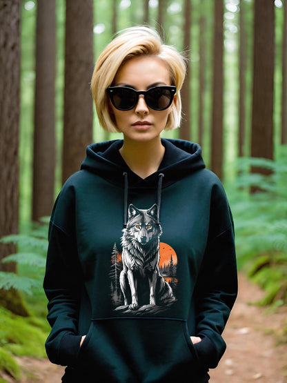 This Wolf Hoodie is a haunting depiction of the North American Grey Wolf. This beautiful animal is on the endangered species list. This image features a stunning grey wolf with a beautiful orange sunset with a forest of muted grey pine trees.