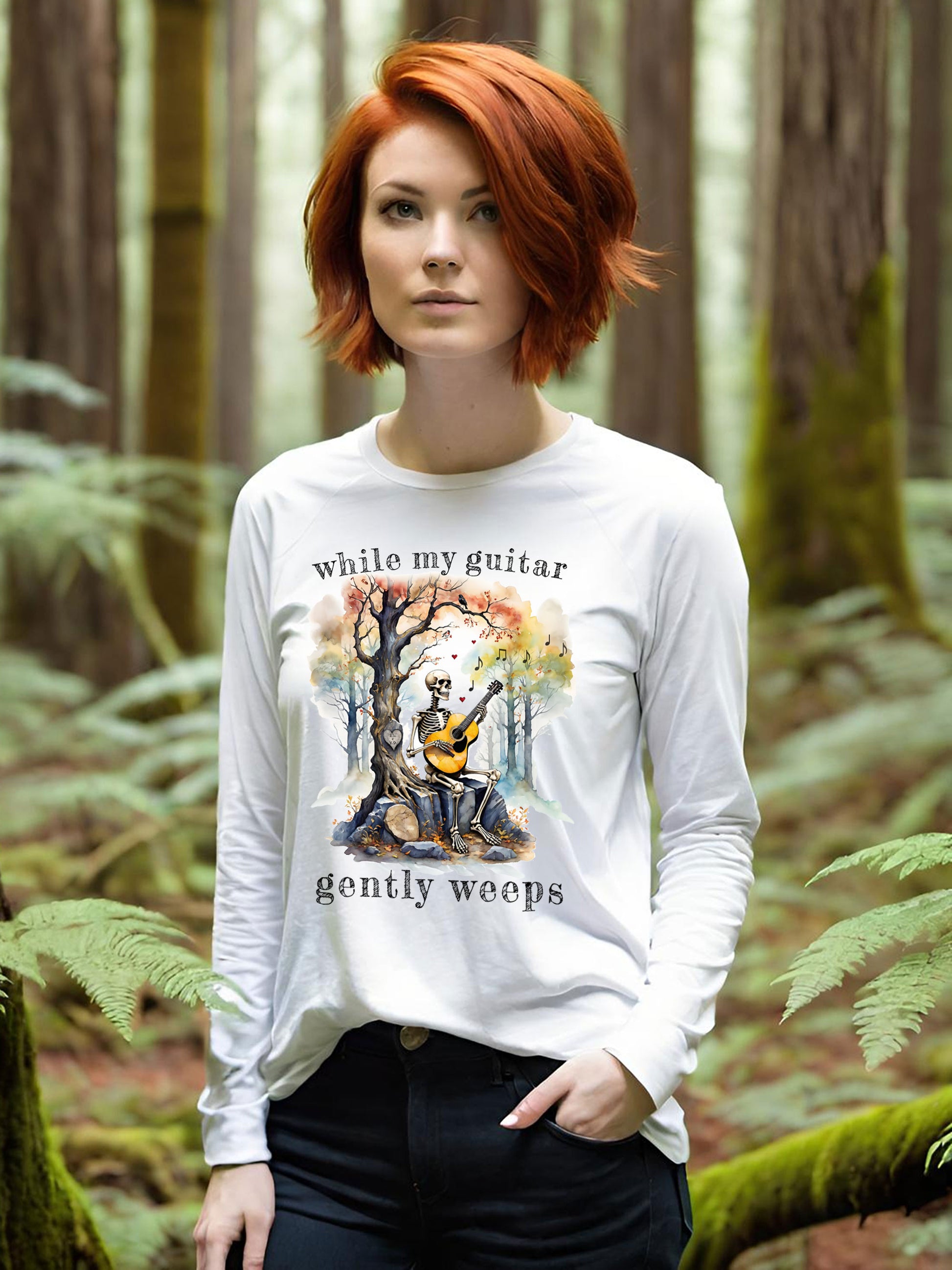 This gothic skeleton long sleeve t-shirt featuring a grisly guitarist jamming on an acoustic guitar in a haunting watercolor forest is a stunning tongue-in-cheek homage to the Beatles music. This stylish lady looks great in this Gildan unisex heavy cotton long sleeve t-shirt.